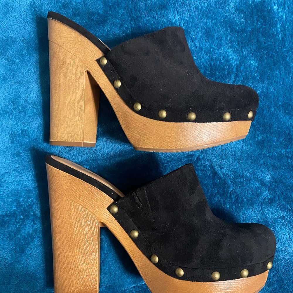Black slide clogs with studs and brown bottom.